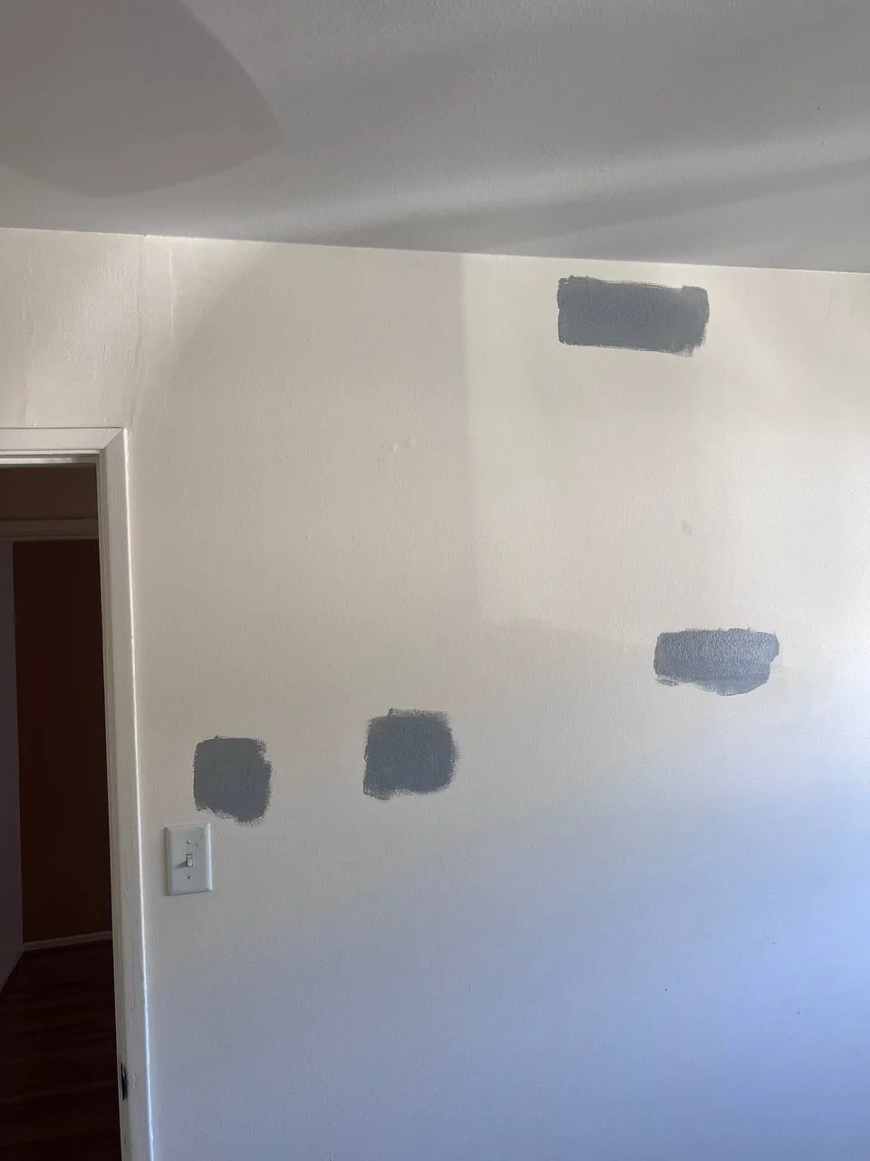 Drywall patch repair in San Diego — gray joint compound patches on white wall