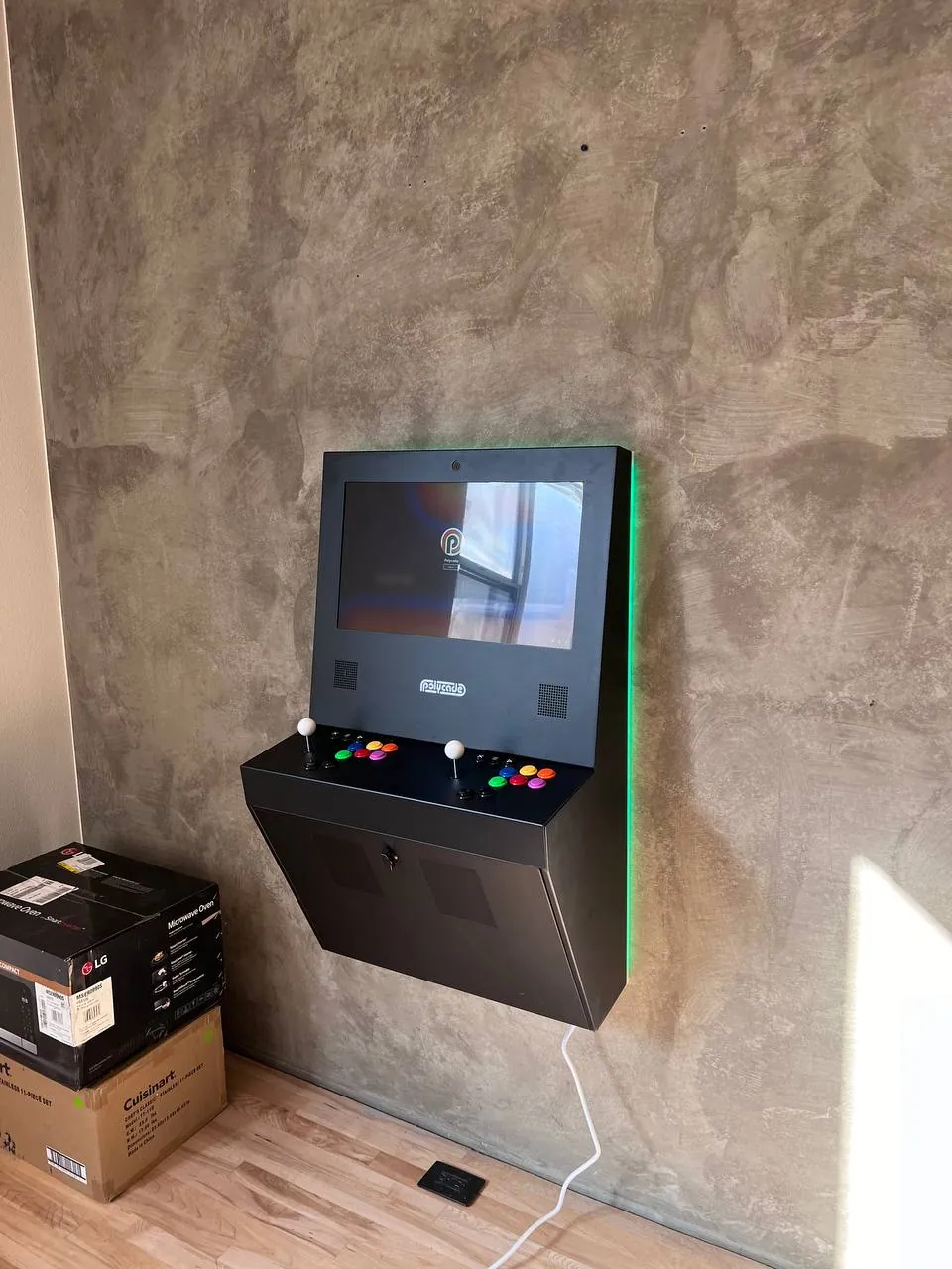 Wall-mounted arcade cabinet with concealed cables in a San Diego game room